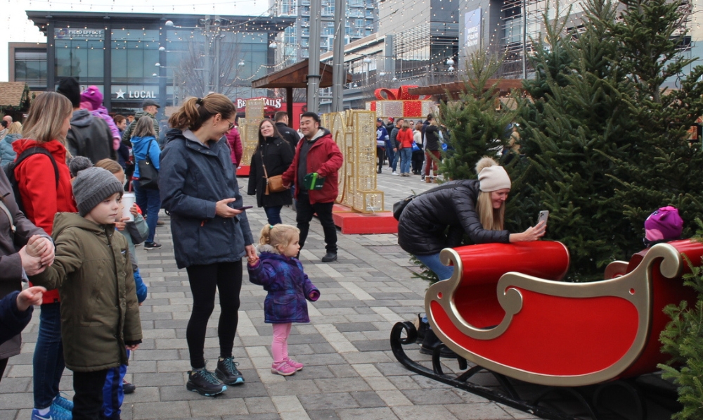 People at the Ottawa Christmas Market taking photos of their children